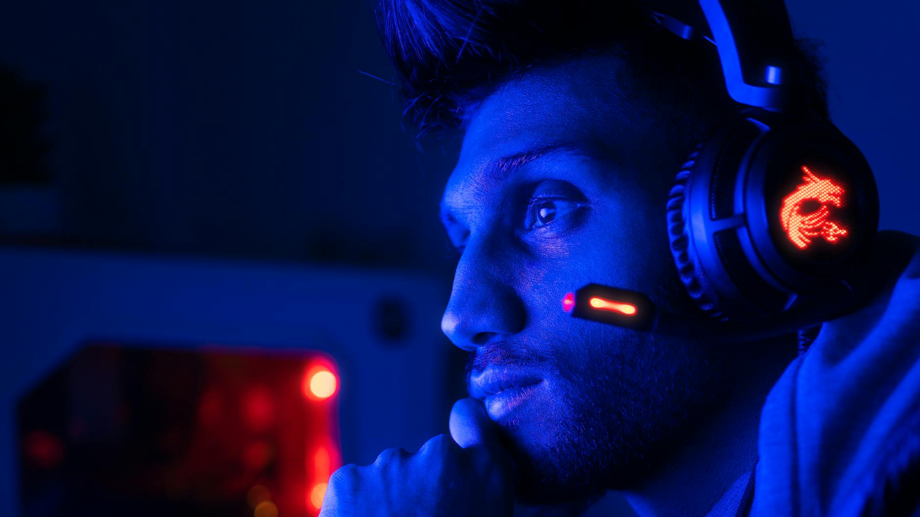 man playing pc game with headphones